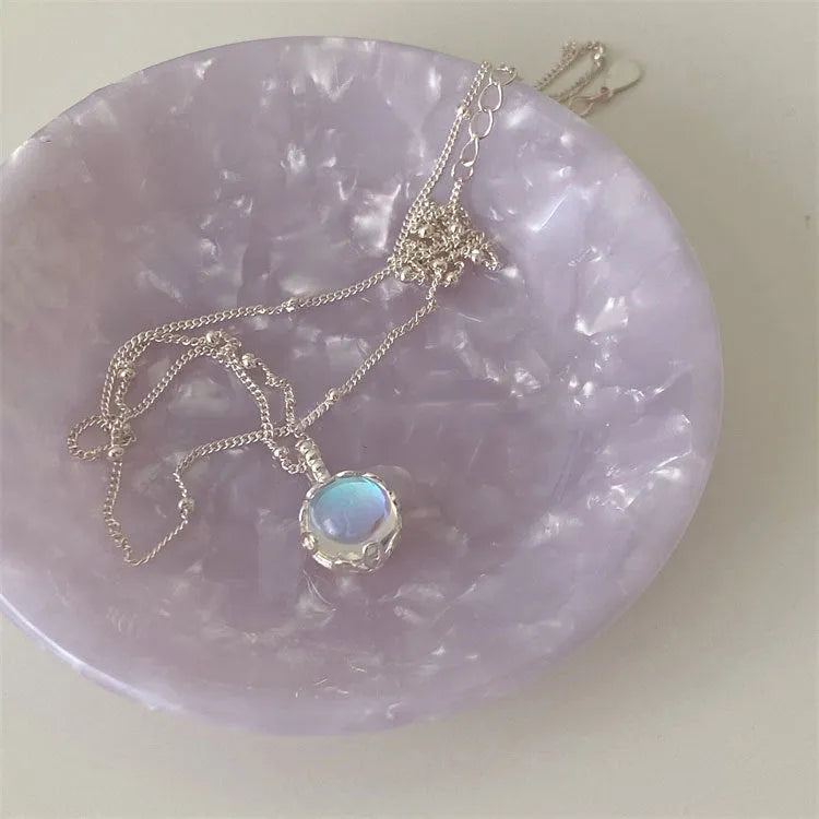 Round geometric 925 silver ornamental stone pendant on a silver curb chain necklace for women.