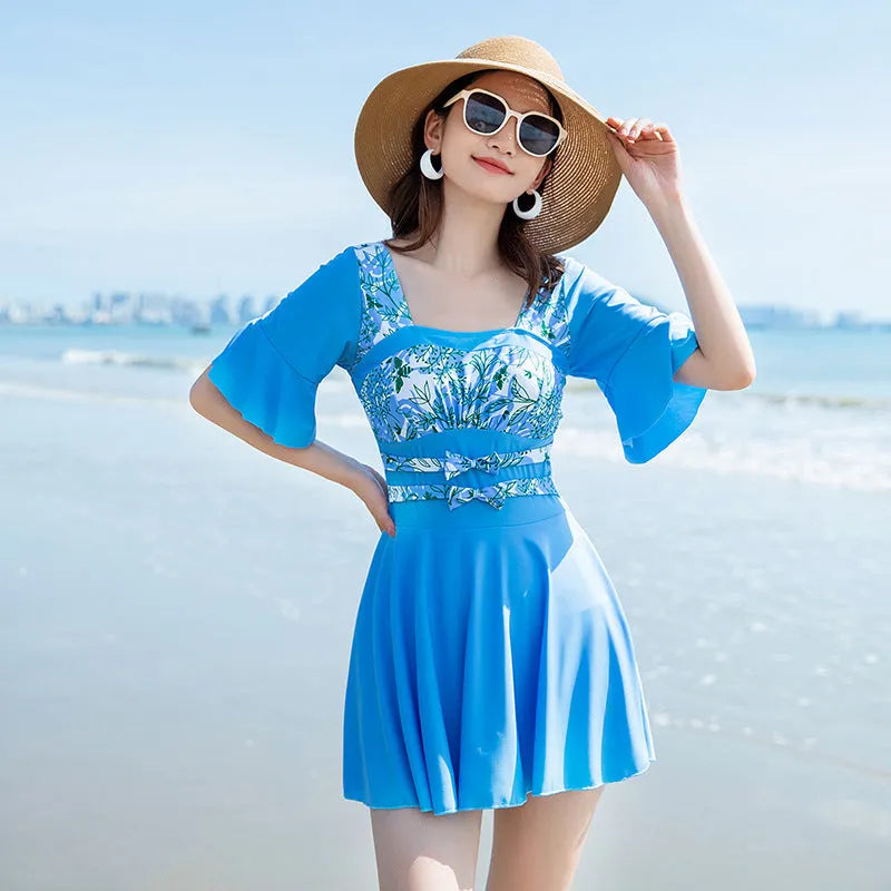 Green and blue printed one-piece swimsuit for women, shown in sizes M L XL 2XL.