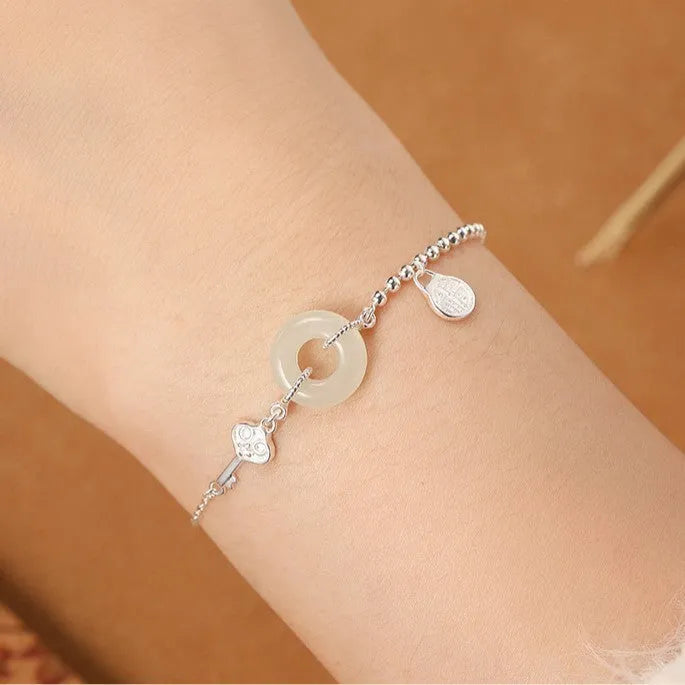 Silver bracelet with geometric peace buckle charm containing Hetian jade, traditional Chinese women's jewellery