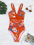 Women's floral print backless one-piece swimsuit on a model, showing the tight fit and stretchy fabric.