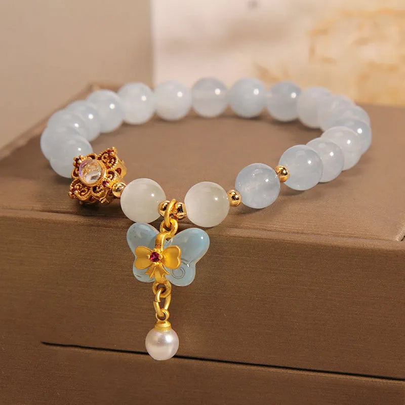 Women's crystal bracelet with a blue aquamarine butterfly pendant and sparkling rhinestone details on an adjustable chain.