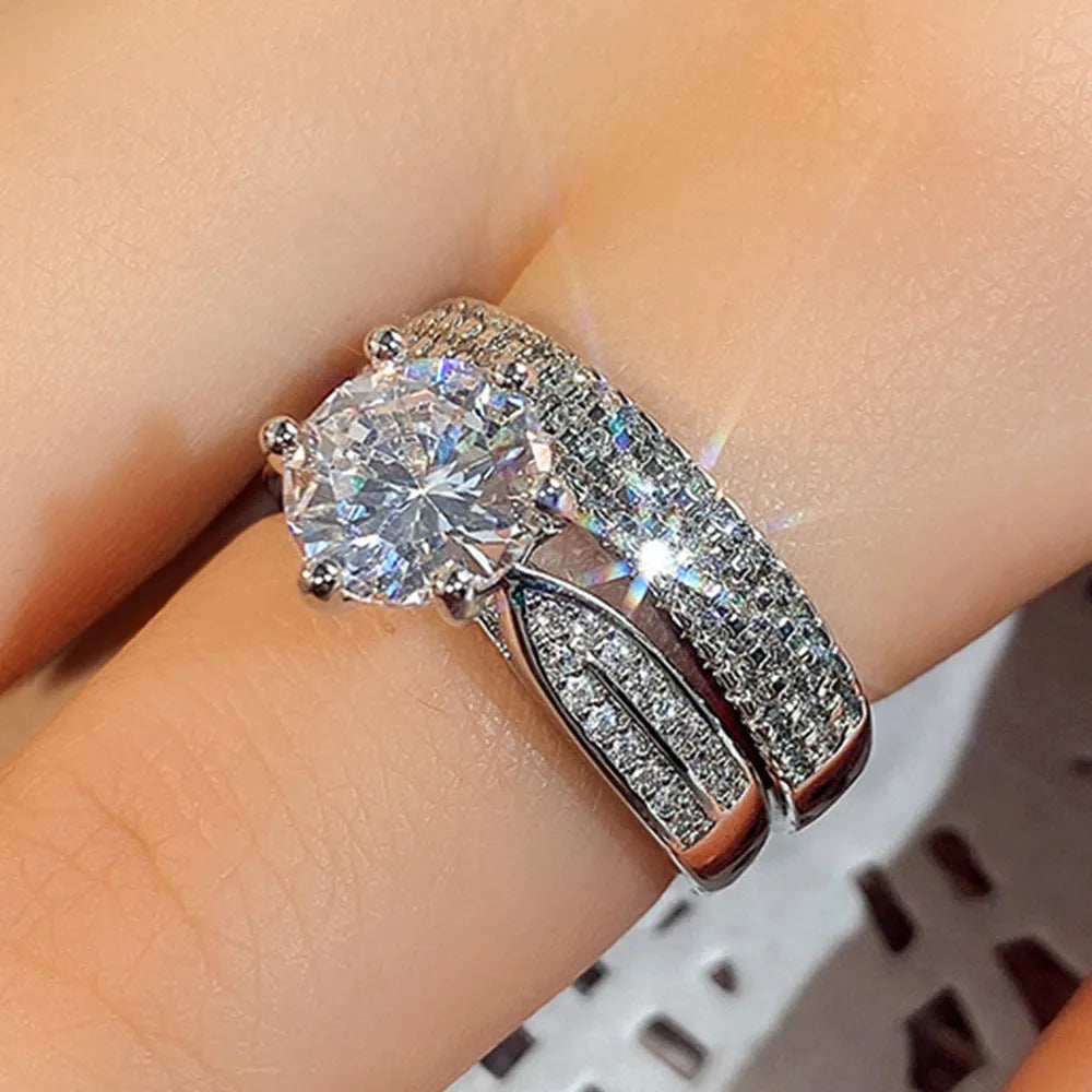 White gold colour alloy combined ring and bracelet with geometric shape and round details.