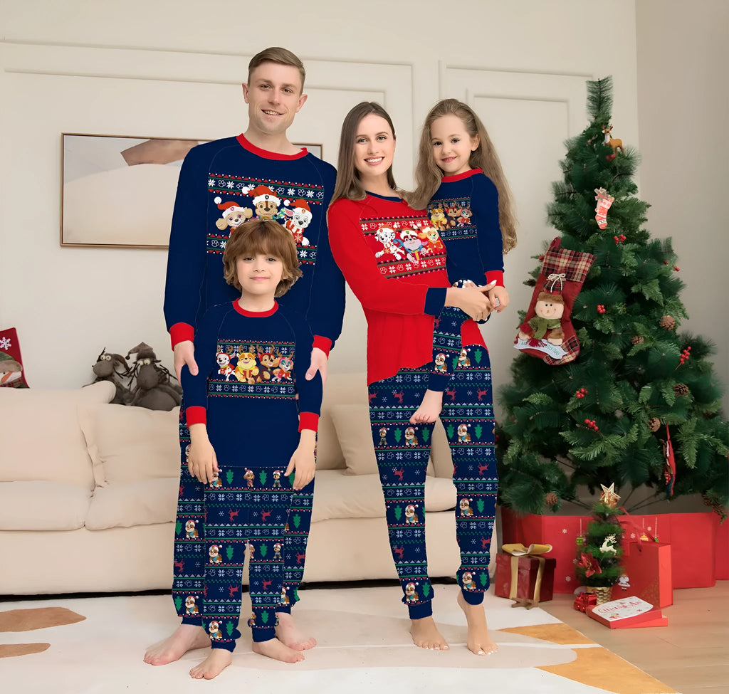 Family wearing matching red deer plaid Christmas pyjamas with adults, children, baby, and dog