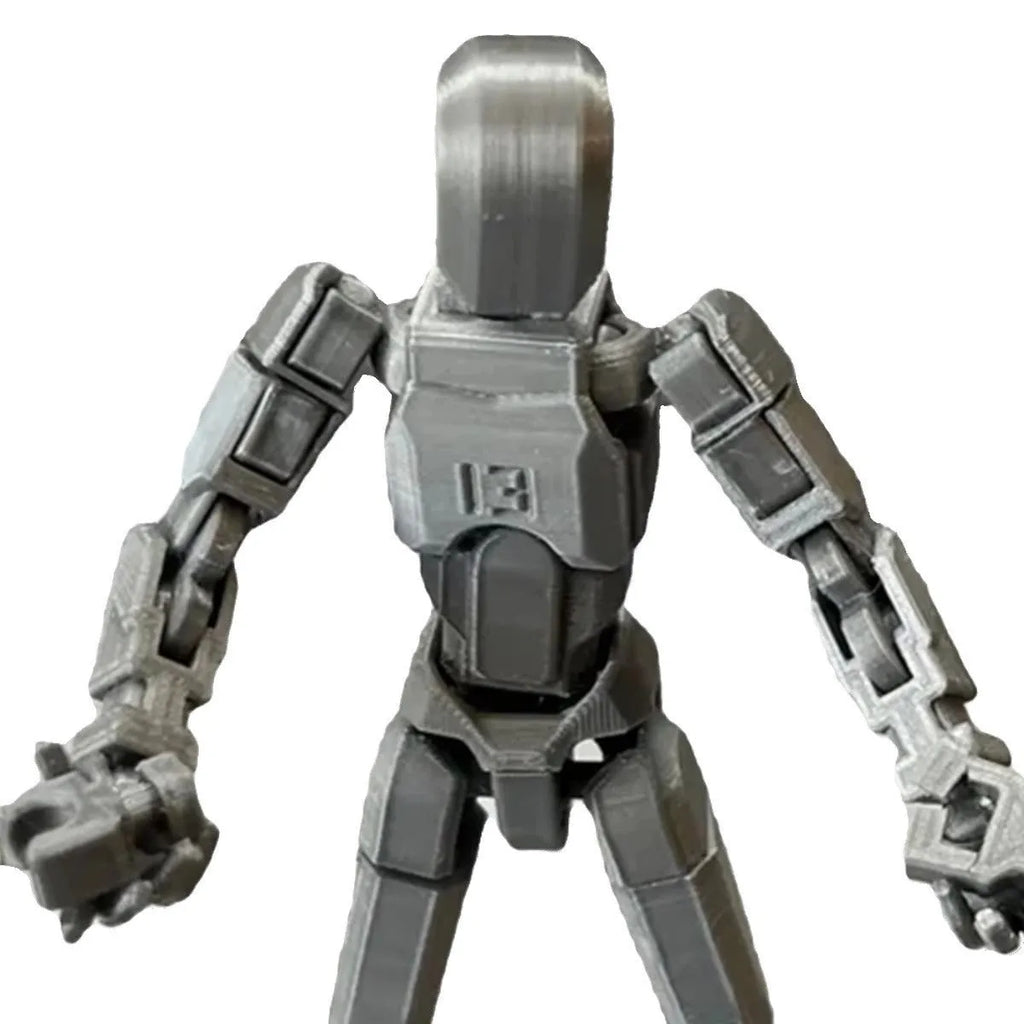 Multi-jointed 3D printed robot action model with movable limbs on a desk.