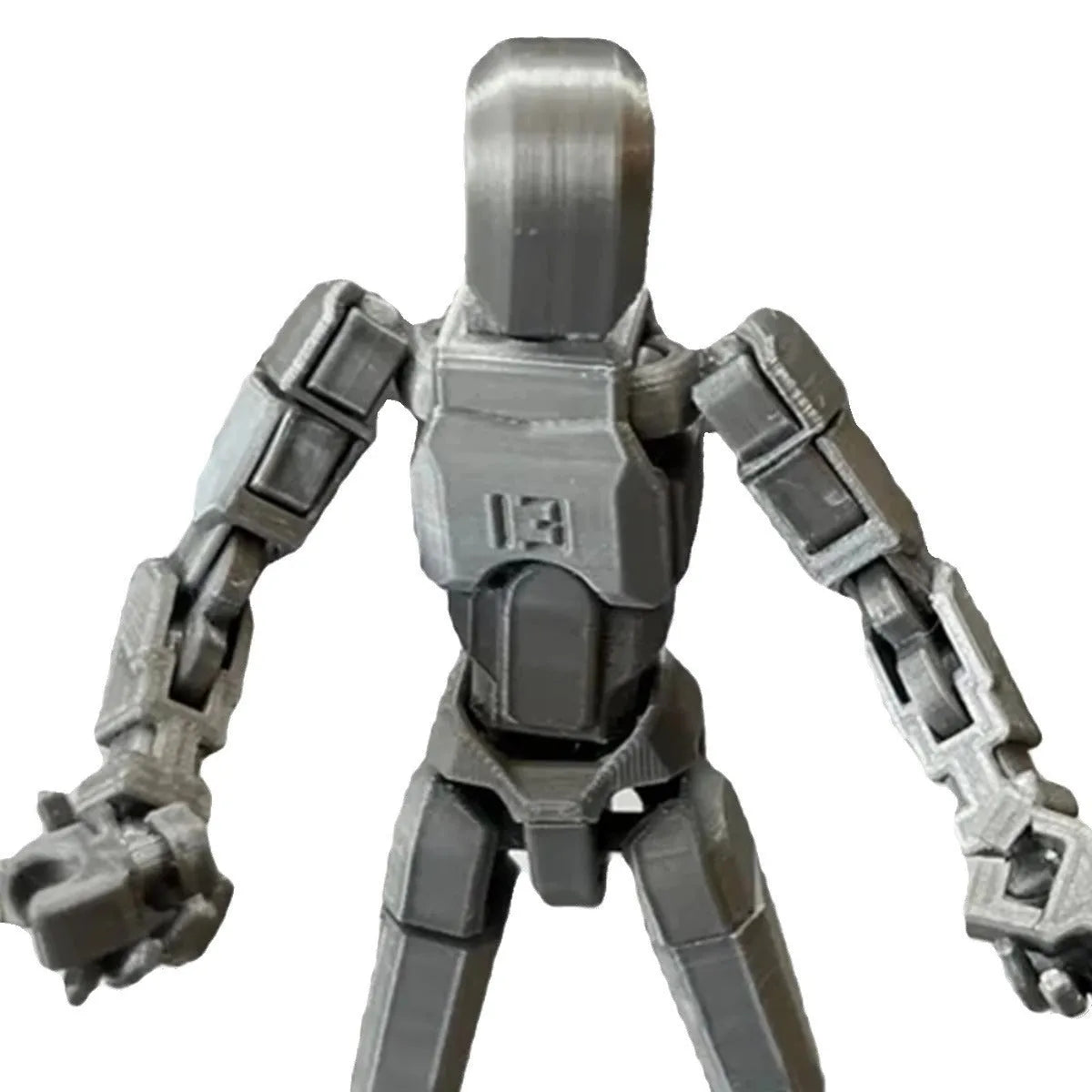Multi-jointed 3D printed robot action model with movable limbs on a desk.