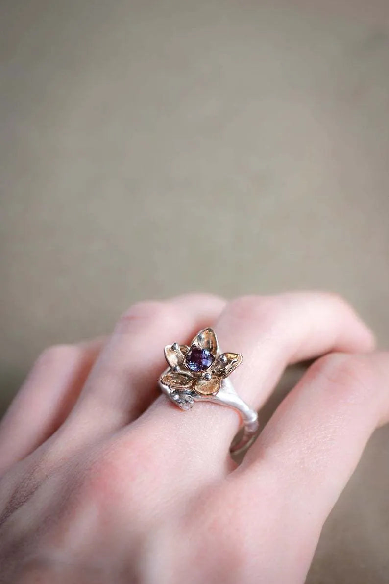 Silver two-tone floral geometric alloy women's ring on a plain background.