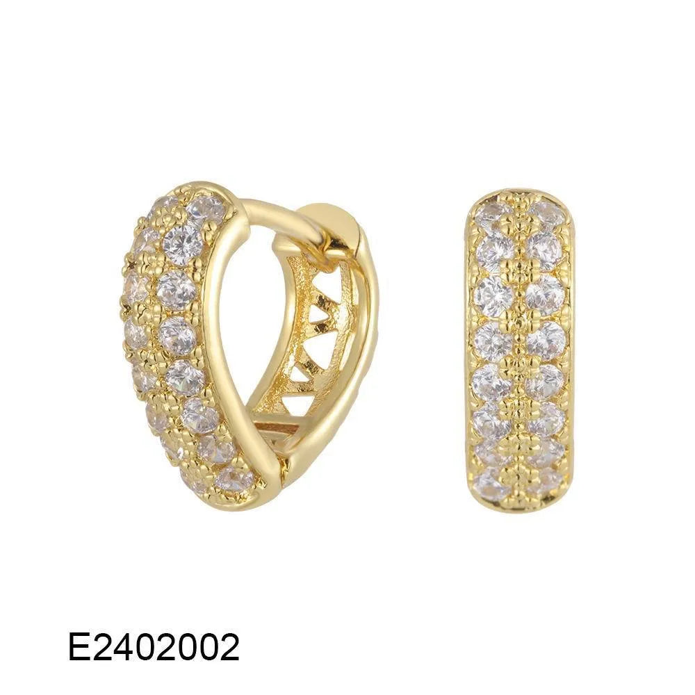 Brass gold plated heart shape clip-on earrings with gang drill detailing on a copper base.
