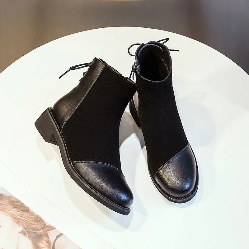 Black women's above-the-knee Martin boots with a side zipper, round toe, and decorative bow.