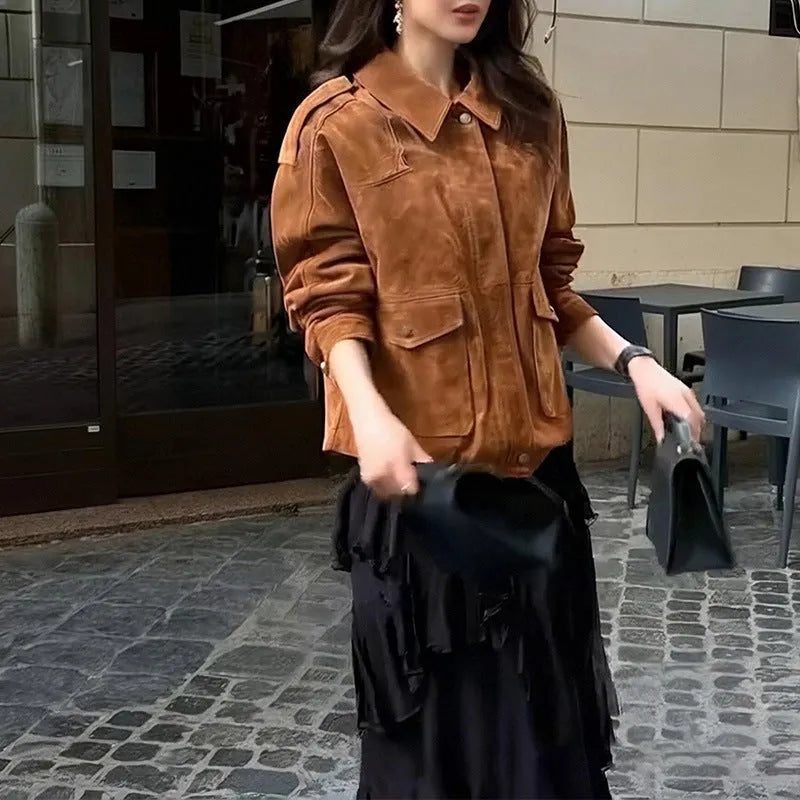 Women's brown suede coat with regular sleeves on a hanger.