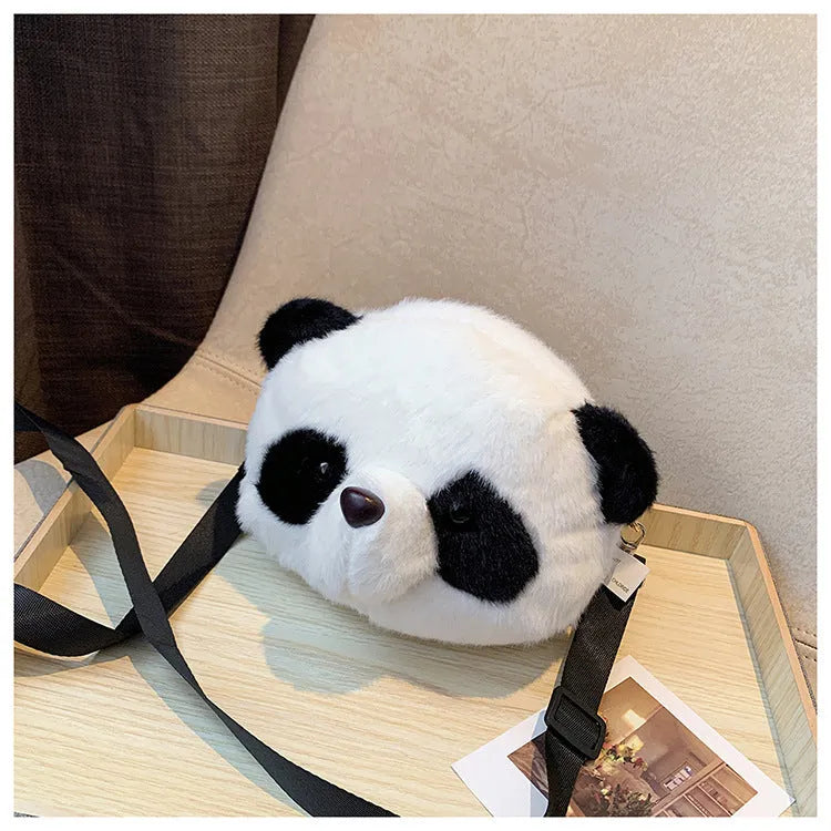 Soft plush panda head design crossbody bag showing cylindrical shape and outer pocket.