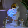 Spaceman starry sky projection lamp on surface showing star projection and speaker grille