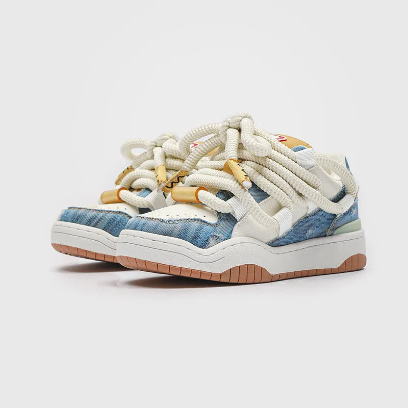 Pair of thick-soled casual lace-up trainers in a solid colour on a white background.