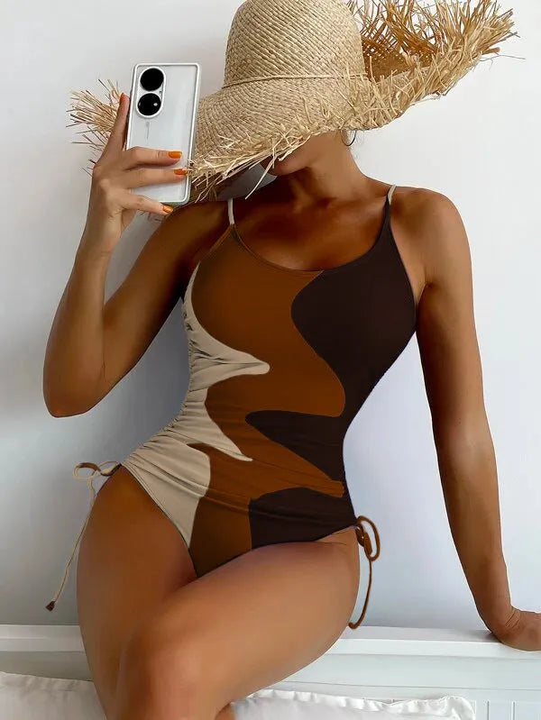 Women's blue one-piece swimsuit with sleeveless backless design and printed stripe pattern