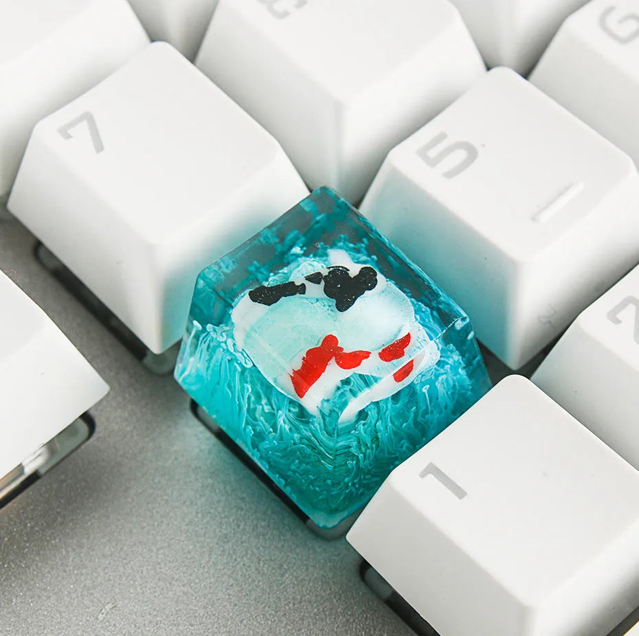 Resin keycap with koi fish swimming through scenery design for Cherry MX mechanical keyboards