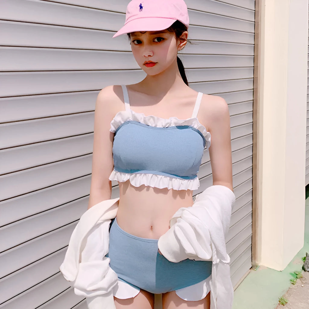 Women's solid colour one-piece swimsuit with suspender straps, designed for swimming.