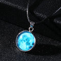 Luminous alloy moon and constellation pendant necklace with a coloured glass cabochon on a chain.