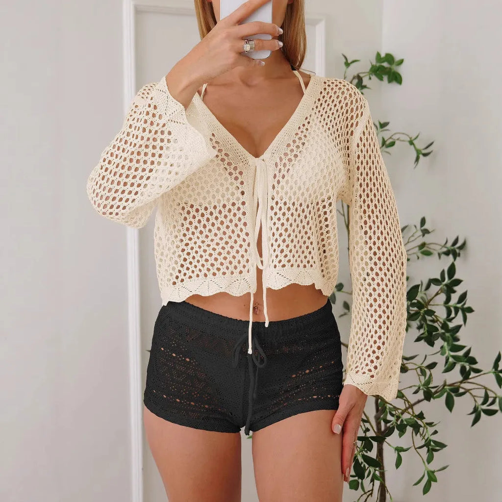Women's apricot cropped cardigan blouse with flared bell sleeves, laid flat.