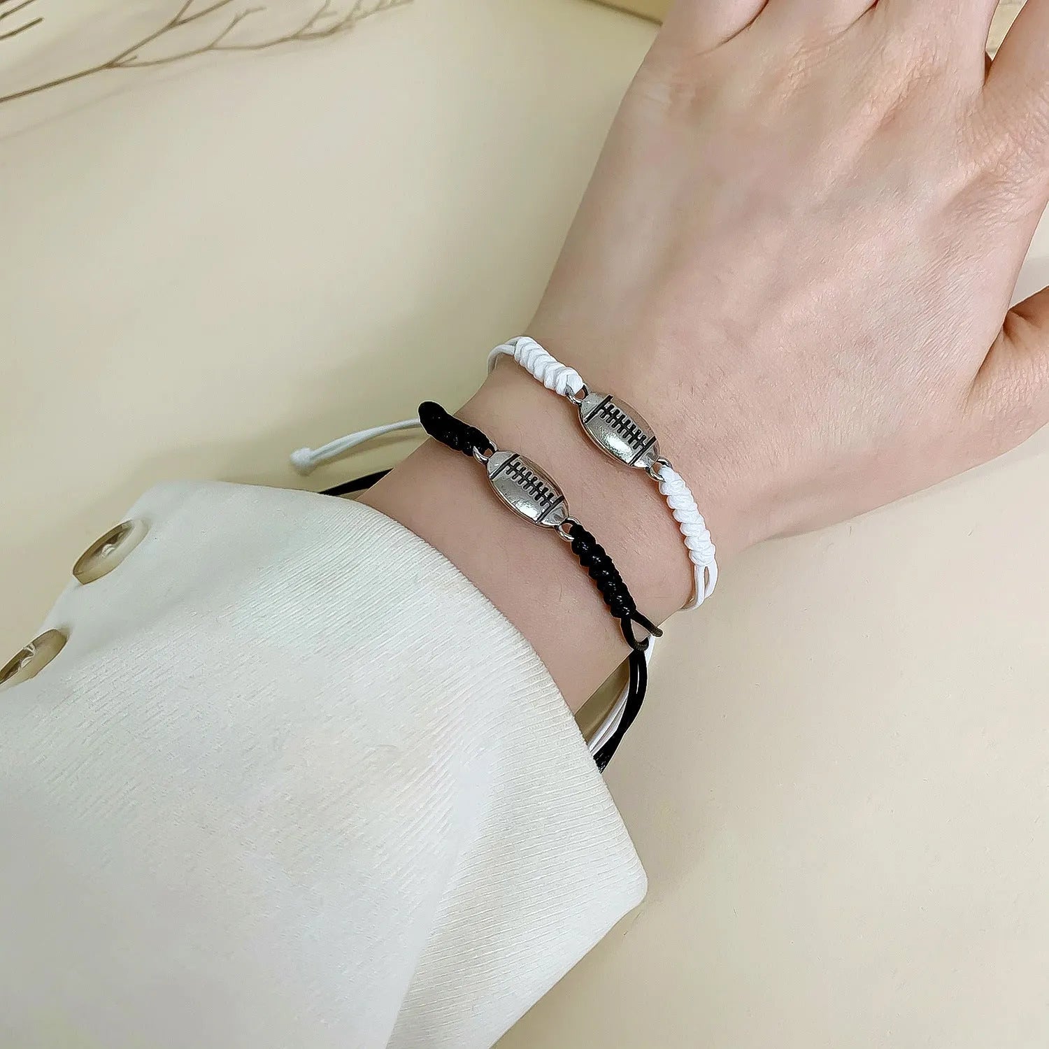 Black and white mixed colour alloy electroplated sports bracelet with geometric square shape on neutral background