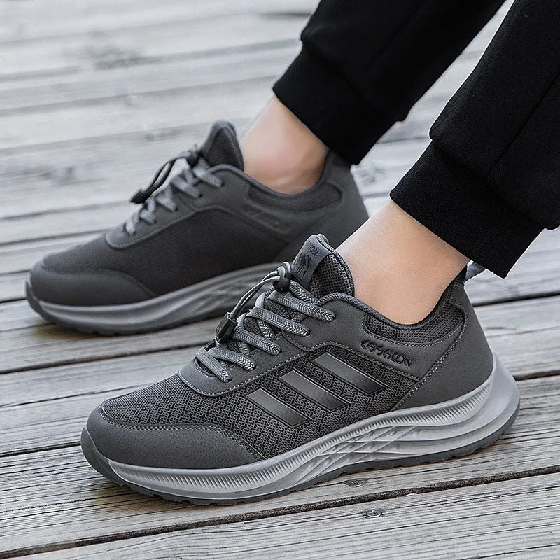 Unisex elastic band slip-on trainer with breathable mesh upper in black, dark grey, purple or purplish red.
