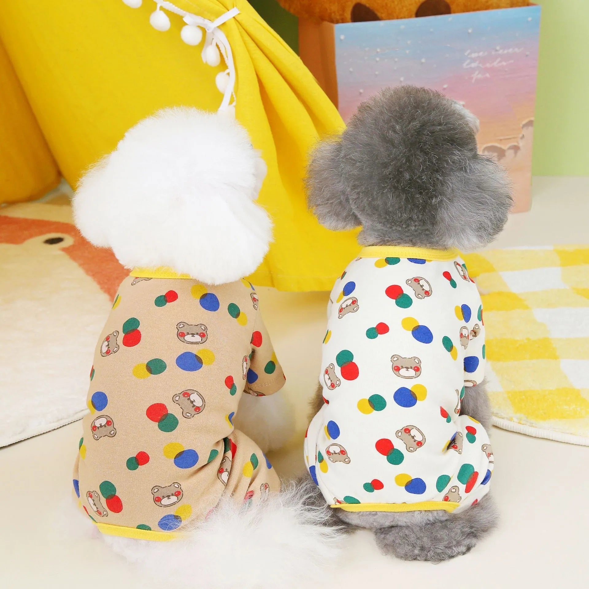 Beige dog t-shirt with a colourful cartoon ball bear design, showing a casual fit on a pet.