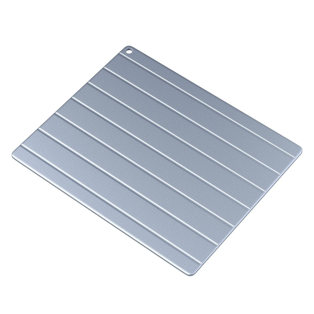 Aluminium household food defrosting plate with modern design on kitchen countertop