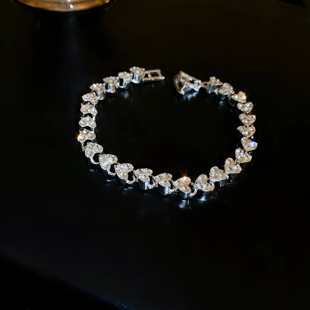 Silver heart shaped metal bracelet with inlaid zircon stones for women