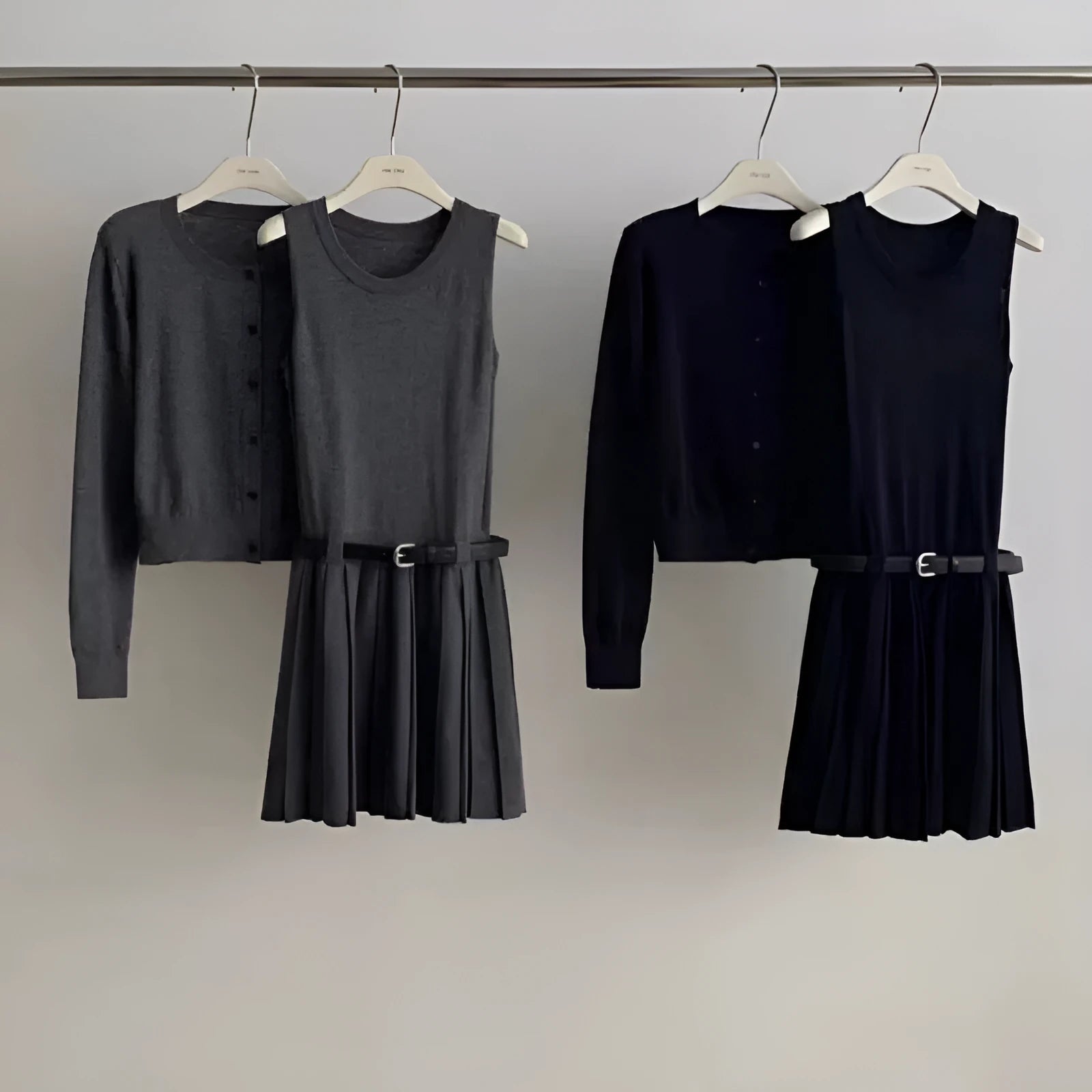 Grey art retro knitted two-piece set for women, showing a vest skirt and long-sleeved cardigan with a belt.