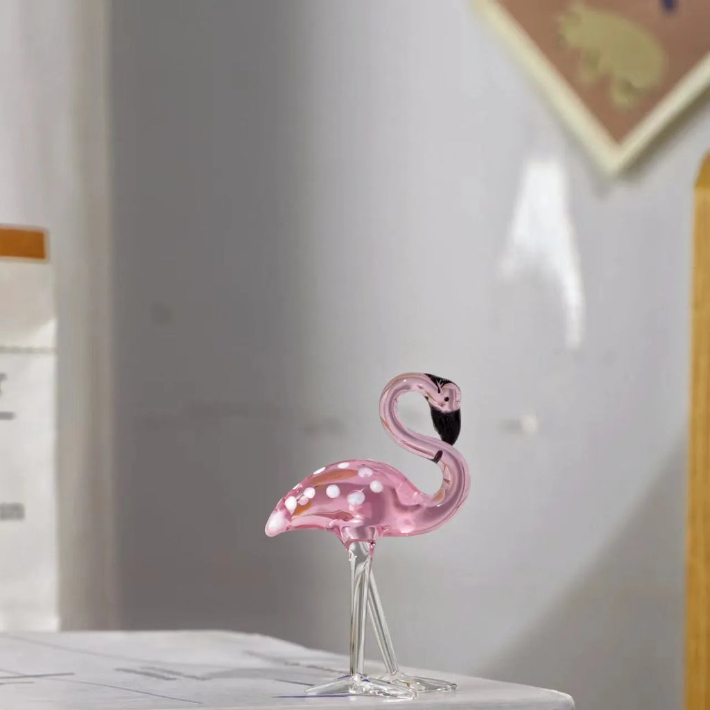 Pink crystal simulation flamingo decorative ornament on a table for home decor or gifting.