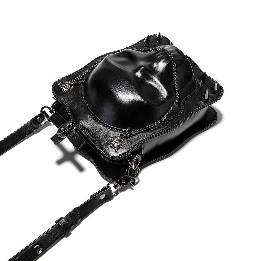 Black square mini crossbody bag with embroidered skull design, metal rivets, and a chain shoulder strap.