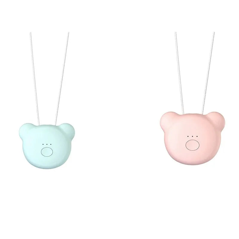 Compact pink USB portable air purifier necklace on a table with charging cable.