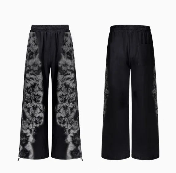 Women's printed loose trousers set in micro-elastic polyester with collage stitching, shown with matching hoodie and shorts.