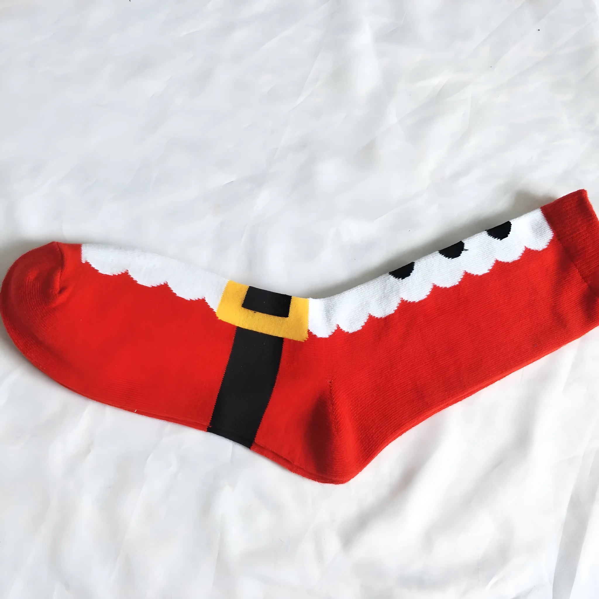 Pair of red Christmas Santa socks with cotton construction, crew length, and festive design