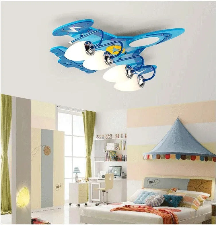 Children's cartoon airplane design LED ceiling light with glass shade and wood fitting.