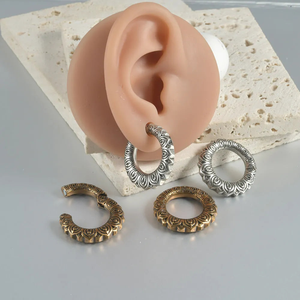 Large antique silver dragon-shaped earrings with hollow-out geometric design.