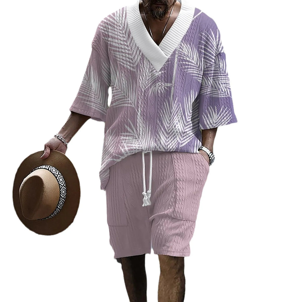 Man wearing a printed drop-shoulder knitted top and matching shorts from a casual summer suit.