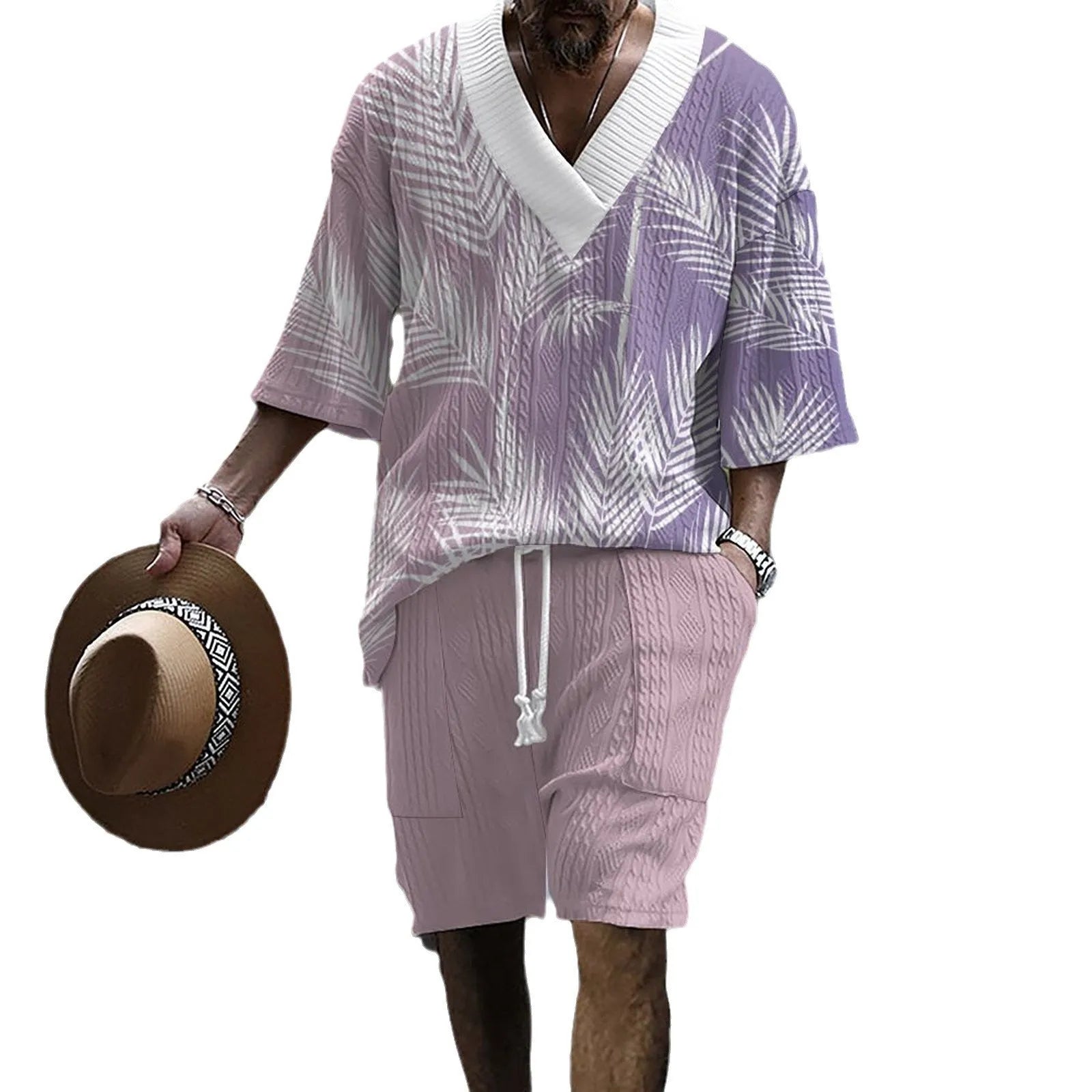 Man wearing a printed drop-shoulder knitted top and matching shorts from a casual summer suit.