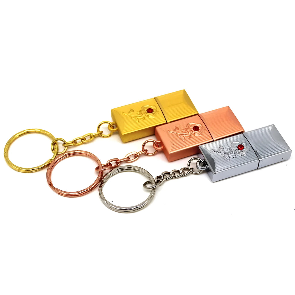 Metal and crystal USB flash drive in gold finish with decorative crystal front on white background