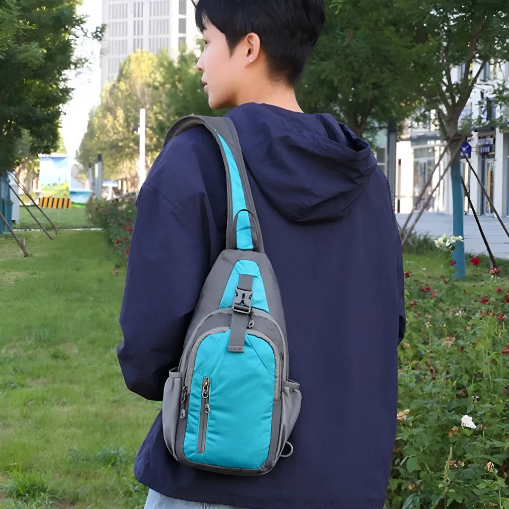 Unisex nylon crossbody chest bag in army green colour, shown worn casually.