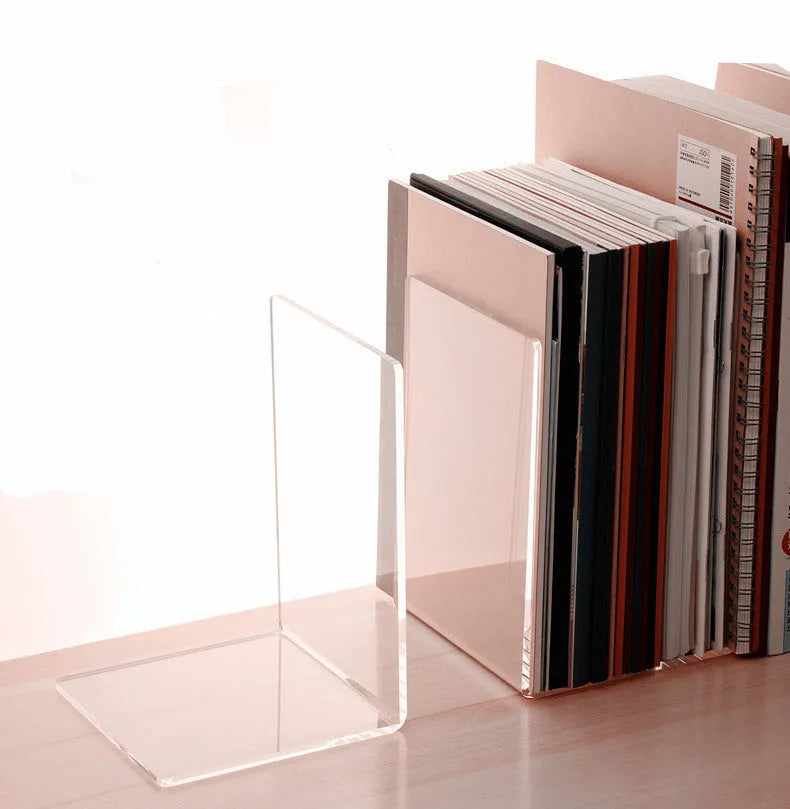 Transparent acrylic bookshelf displaying organised books on a study desk