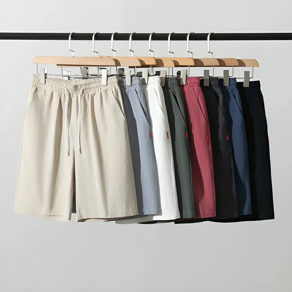 Solid colour cotton-linen cropped trousers with a drawstring waist on a hanger.