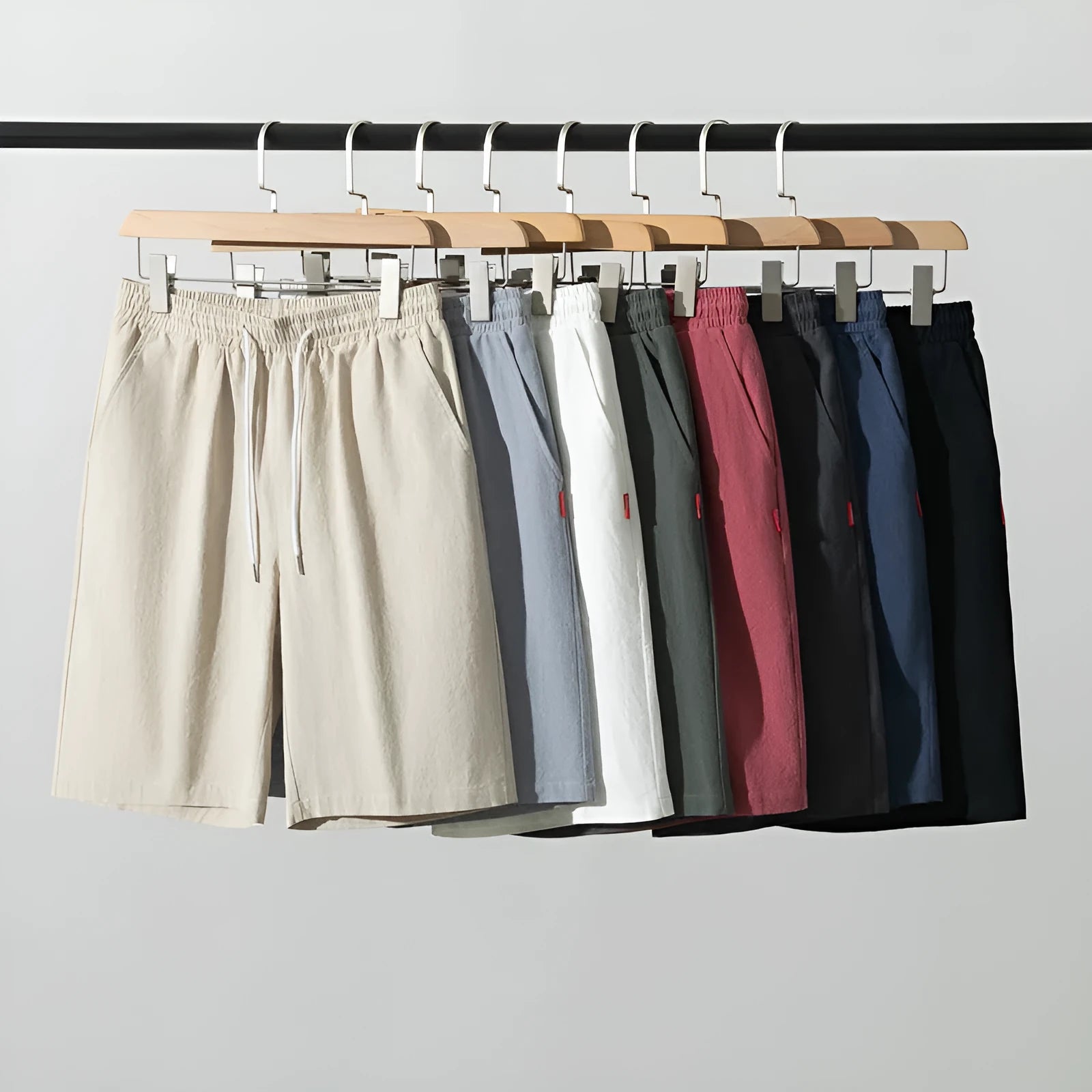 Solid colour cotton-linen cropped trousers with a drawstring waist on a hanger.