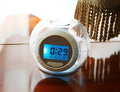 White colourful natural sound alarm clock with large LCD display showing time and temperature, featuring 6 nature sounds and 7 colour cycle night light