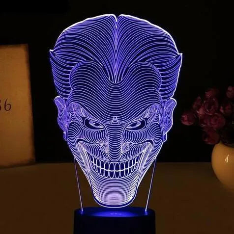 A 3D acrylic LED lamp emitting a gradient of colours, shown with its square base and remote control.