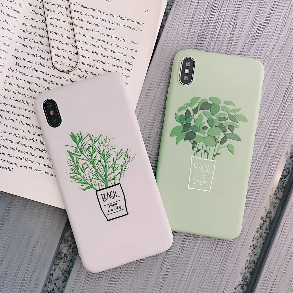 White silicone iPhone case with a painted green plant pattern on the back.