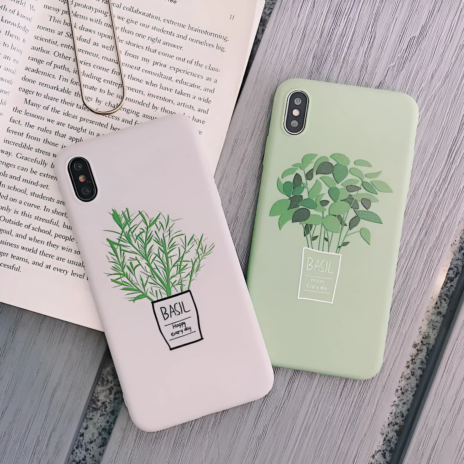 White silicone iPhone case with a painted green plant pattern on the back.