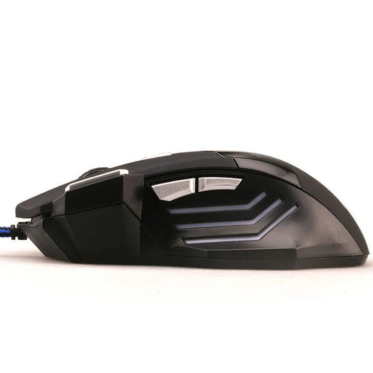 Black wired USB gaming mouse with Tyrannosaurus Rex design, six buttons, and colourful LED light on a desk
