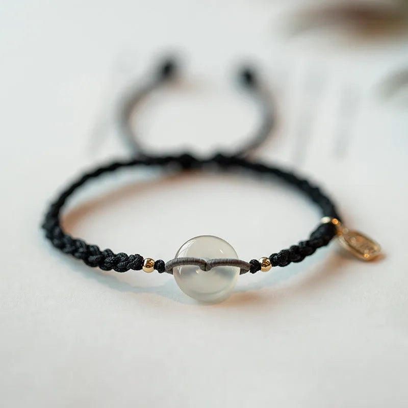 Crystal bracelet with weaving construction and ethnic style design featuring flower-shaped accents on rope strap