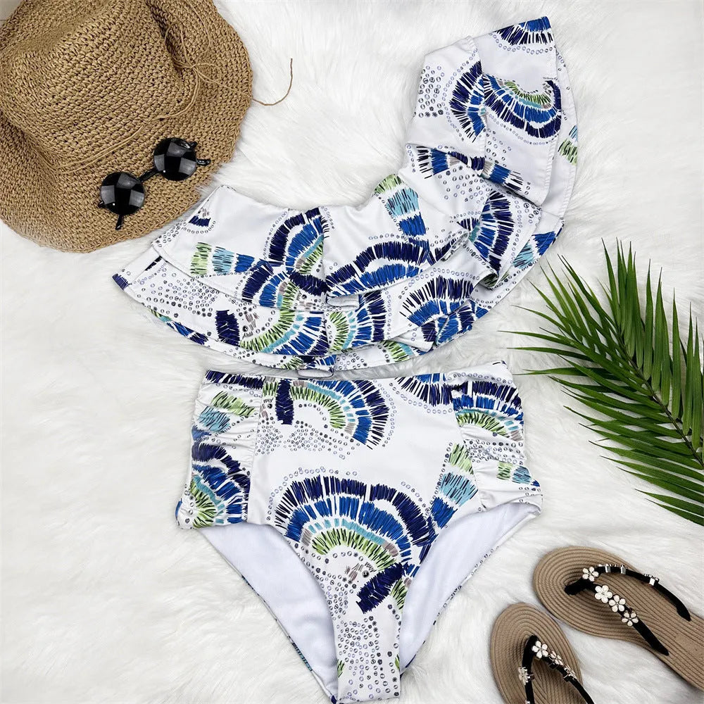White women's one-shoulder swimsuit with large lotus leaf detail and split design