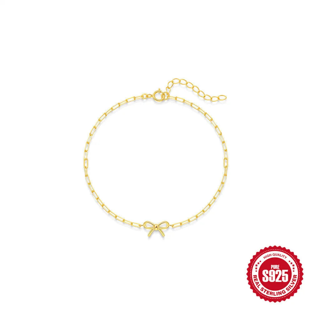 Gold tone S925 sterling silver bracelet with heart charm and clip chain closure