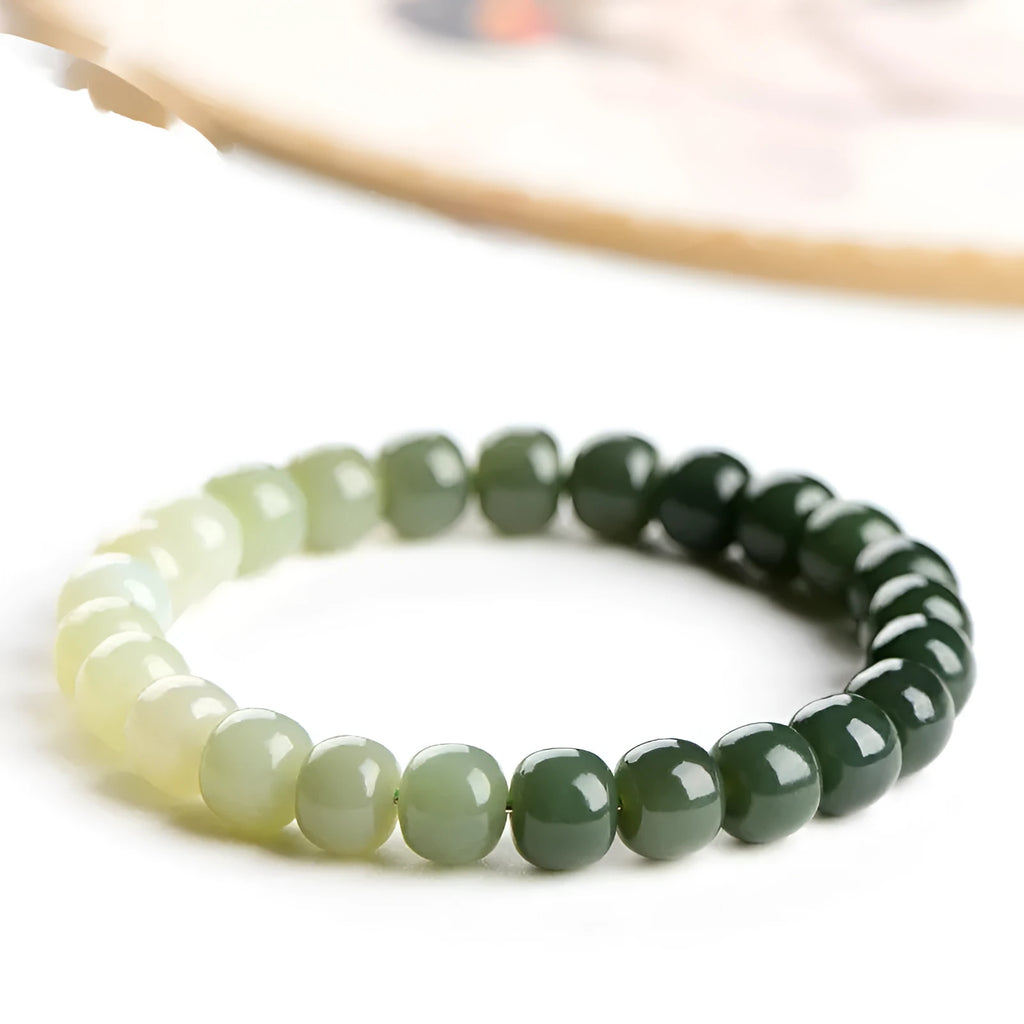Natural Hetian jade water gradient bracelet with polished beads on a wrist.